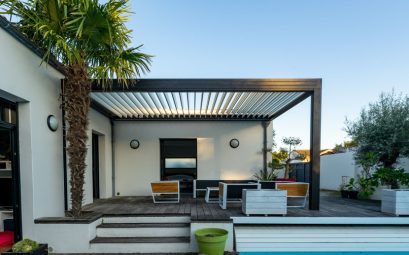 trendy outdoor patio pergola. garden lounge, chairs, metal grill surrounded by landscaping